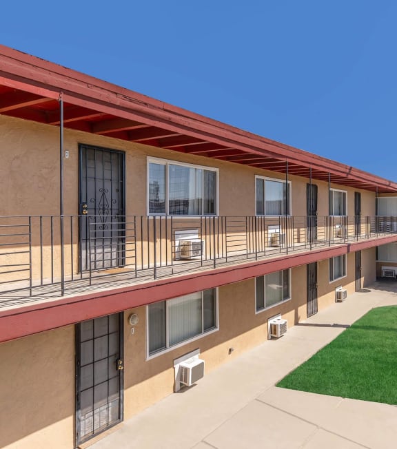 the courtyard of a building with a palm tree and green grass at Oakridge Apartments, Antioch, 94509