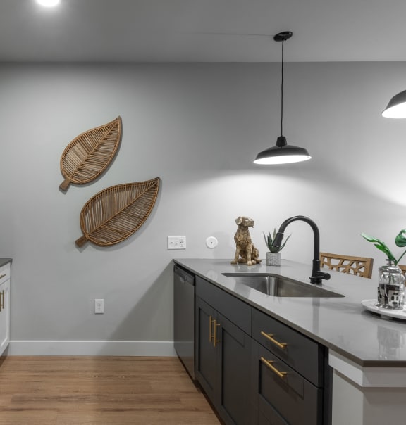 a kitchen with white cabinets and stainless steel appliances and a sink