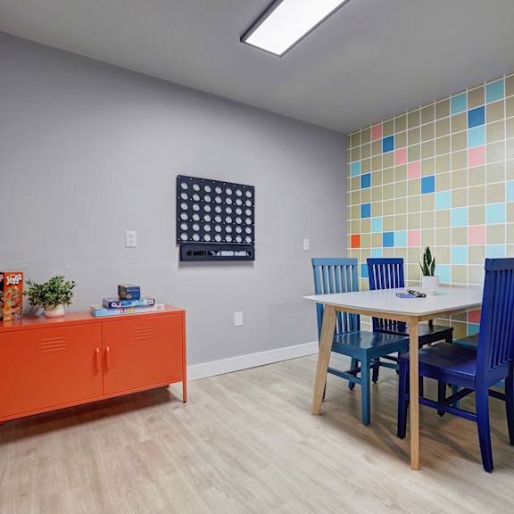 a kitchen with a stove and shelves on the wall