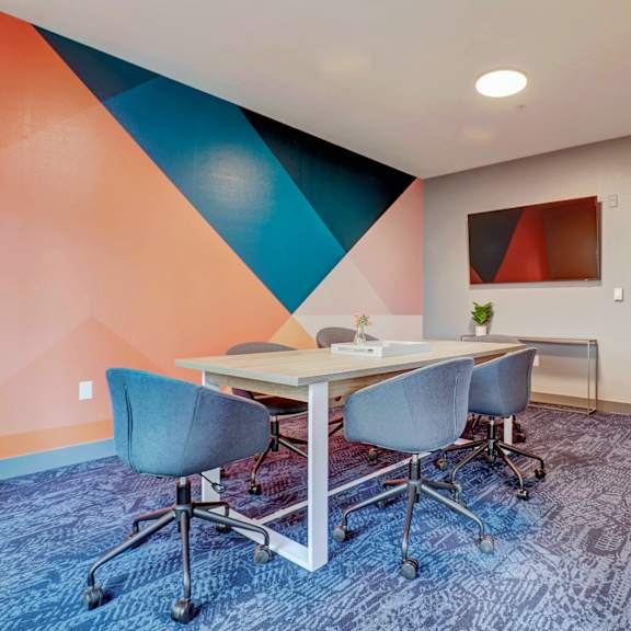 a conference room with a table and chairs