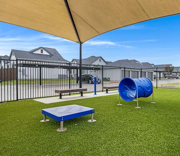 A playground with a blue slide and a yellow canopy.