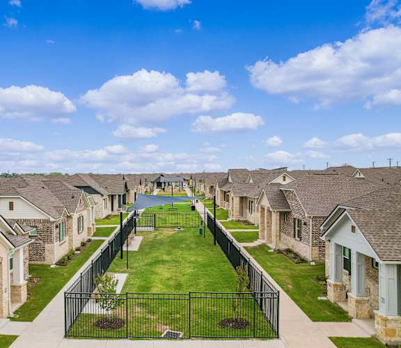 A residential neighborhood with houses and a playground.
