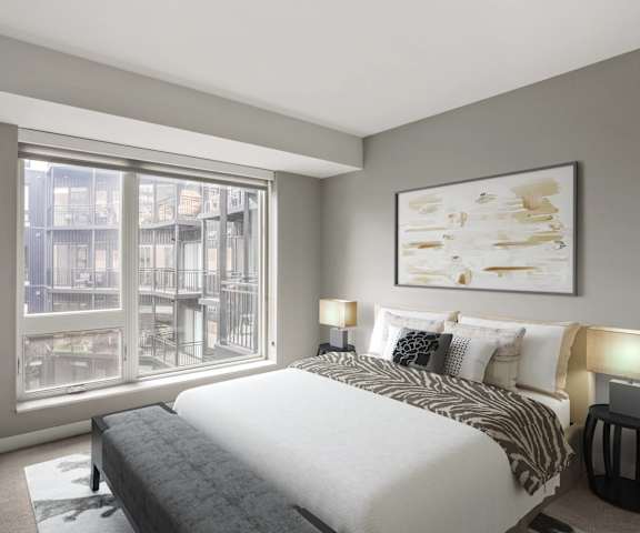 a bedroom with a bed and a large window