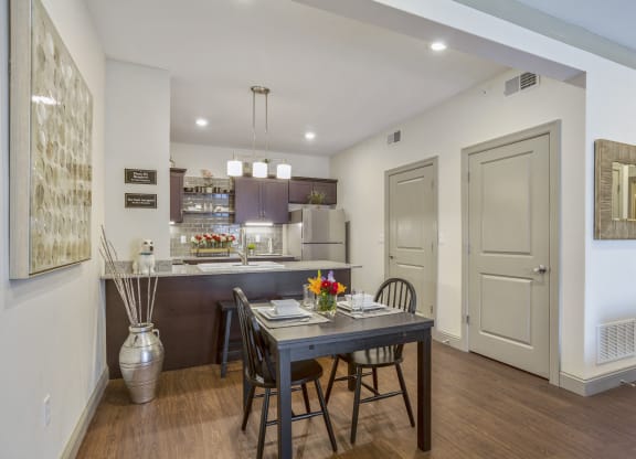 a dining room and kitchen with a table and chairs