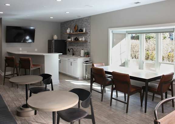 A modern kitchen with a dining table and chairs.