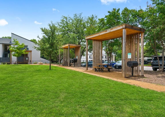 a patio with a grill and a swimming pool