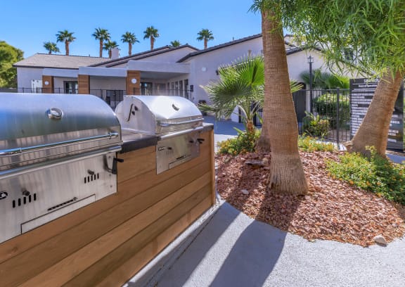 a patio with a grill and a swimming pool