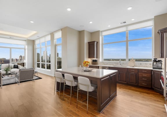 a large kitchen with a center island and a view of a living room