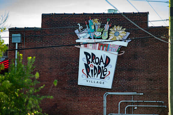 A sign on a building that says Broad Ripple Village.