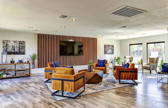 A living room with a wooden floor and furniture.