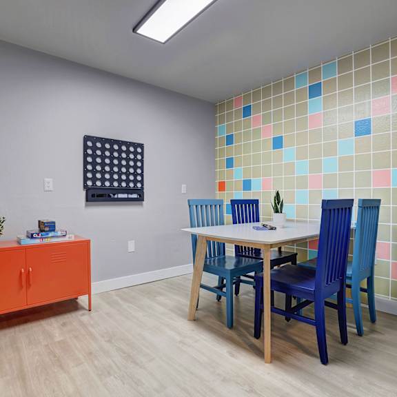 a kitchen with a stove and shelves on the wall