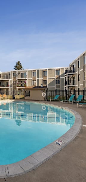 A large outdoor swimming pool surrounded by apartment buildings. at Lou Park, St. Louis Park, MN, 55426