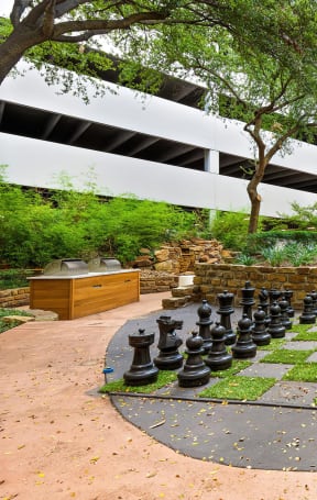 a large chess board in the courtyard of an apartment building