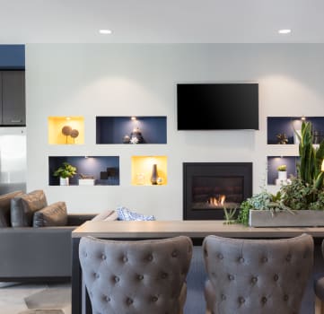 a living room with a fireplace and a tv on the wall
