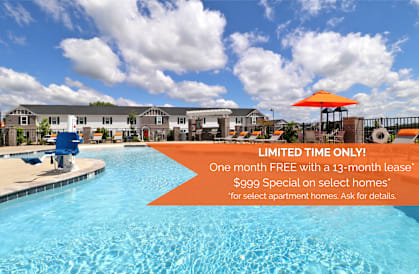 A pool with a sign offering a free month with a lease.
