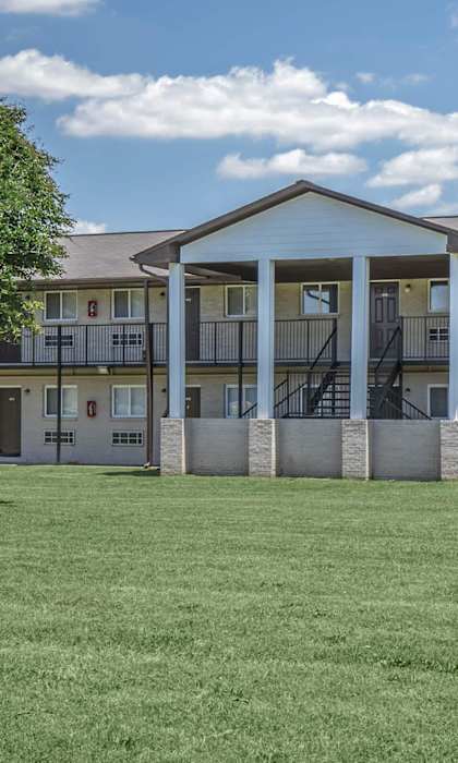 A large building with a tree in front of it.