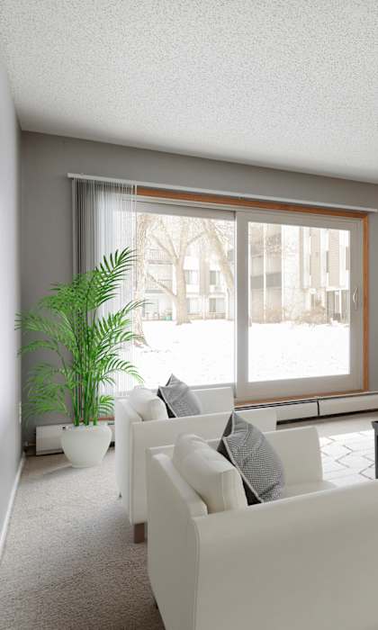 A living room with a white couch, a coffee table, and a large window.