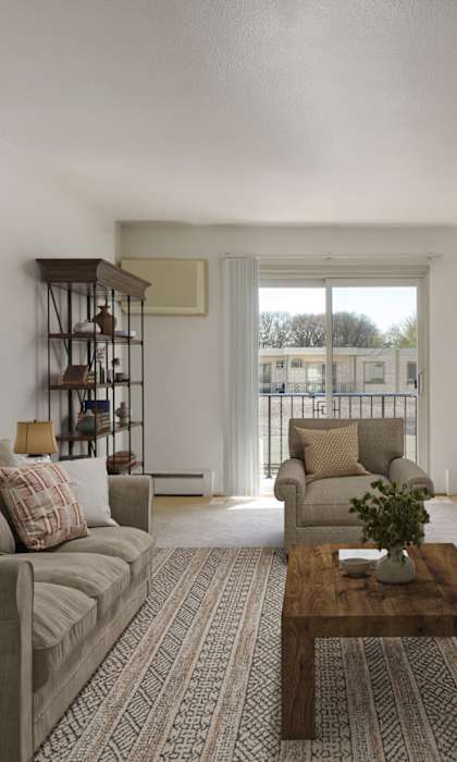 A living room with a grey couch and a wooden coffee table.