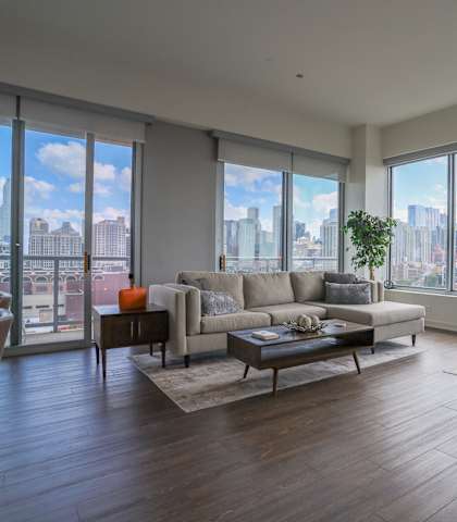 the living room of an apartment with a view of the city