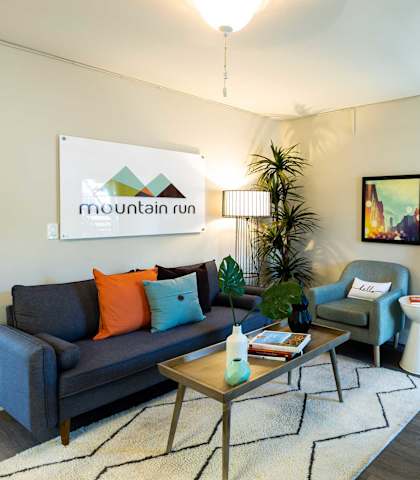 a living room with a couch and a coffee table at Mountain Run Apartment Homes