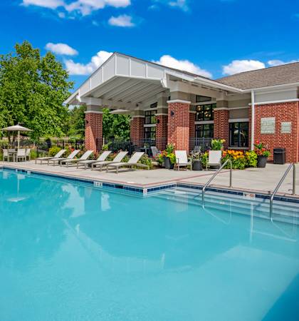 A large swimming pool with a building in the background.