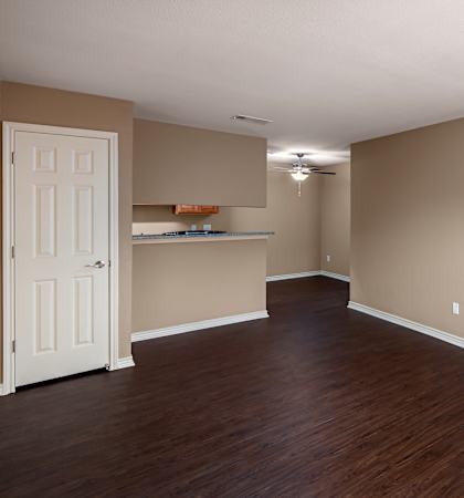 A room with wooden floors and a white door.