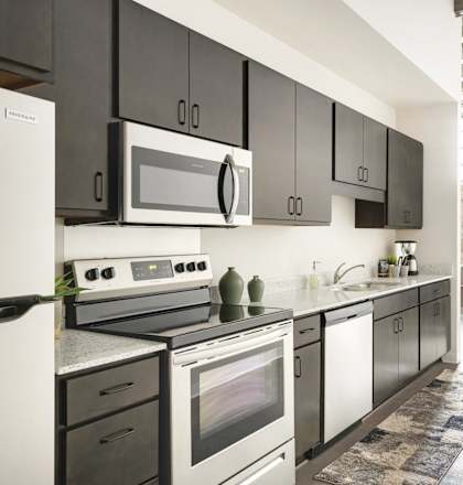 a kitchen with stainless steel appliances and black and white cabinets