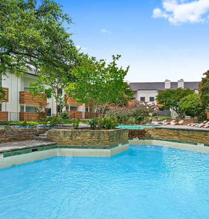 a swimming pool at an apartment building with a blue pool