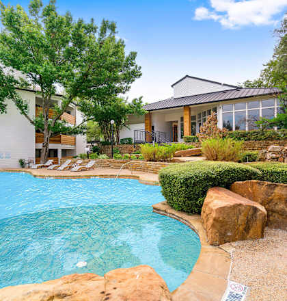 a swimming pool with a building in the background