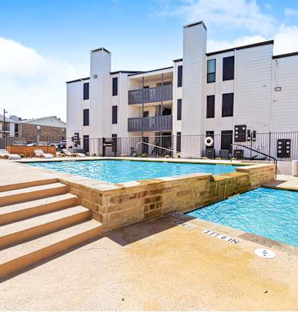 a swimming pool with a building in the background