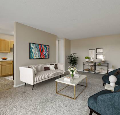 a living room with a couch and chairs and a coffee table