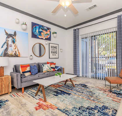 a living room with a couch and a table and a window