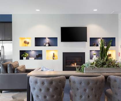 a living room with a fireplace and a tv on the wall