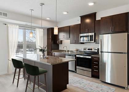 a kitchen with stainless steel appliances and a marble counter top