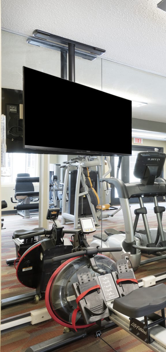 a room filled with cardio equipment and a flat screen tv  at The Kendrick, Minnesota, 55108