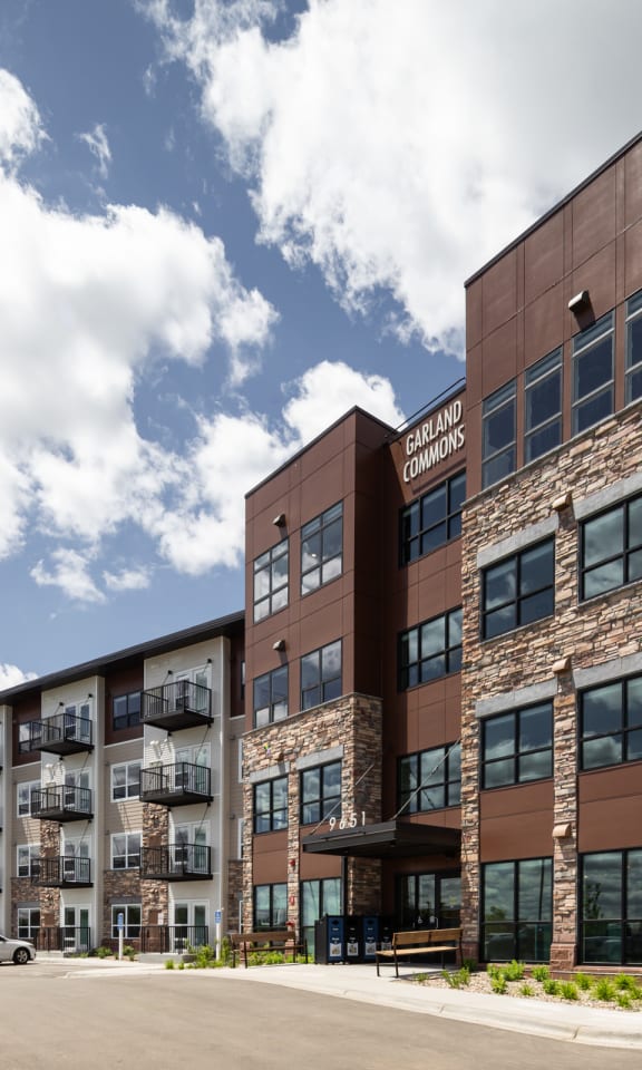 an exterior view of a building with cars parked in front of it