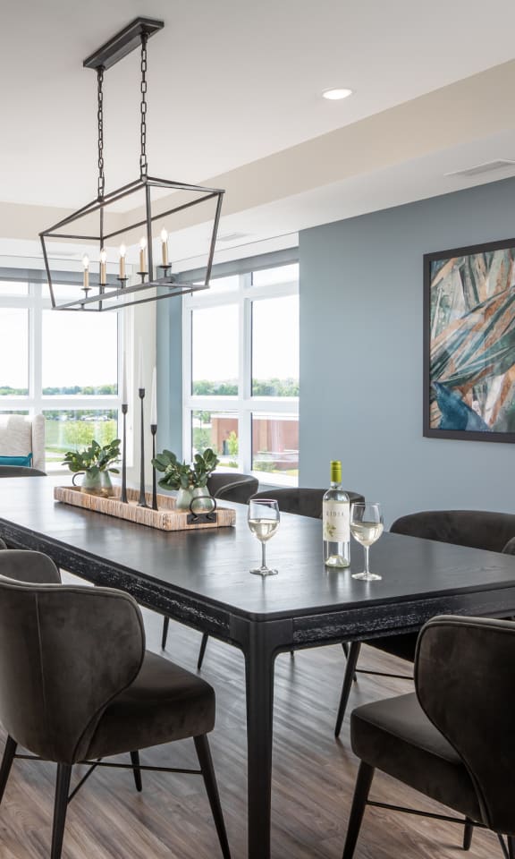 a dining room with a table and chairs and a large window
