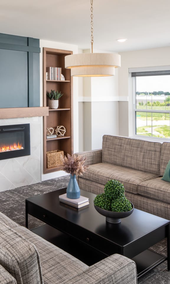 the preserve at gateway living room with couches and a fireplace