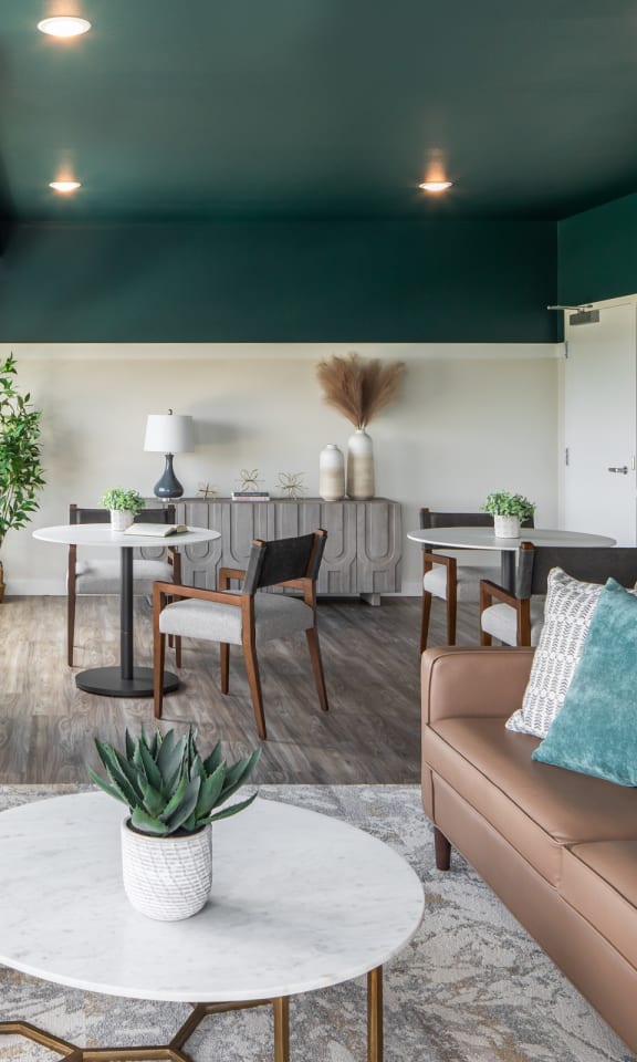 a living room with couches and chairs and a table