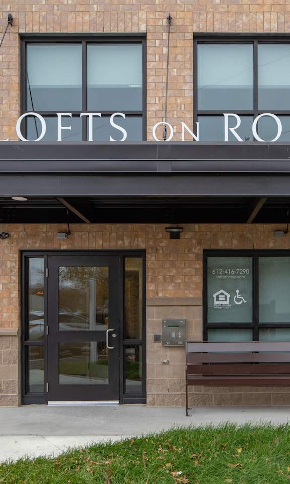The front of a building with the name "Lofts on Rose" on the top.