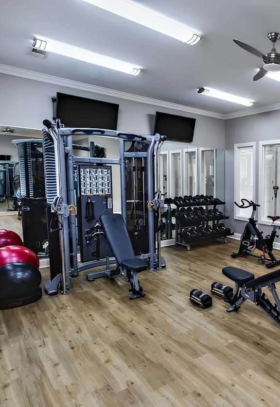 A well-equipped home gym with a variety of exercise equipment.