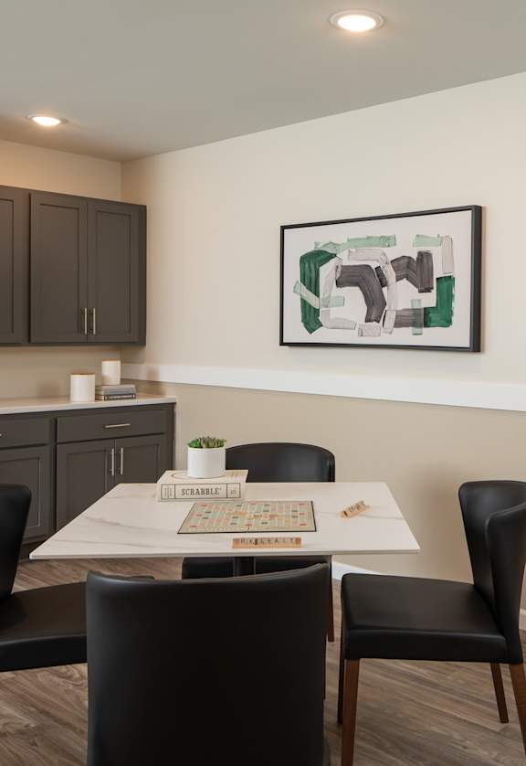 a dining room with a table and chairs and a white board on a easel