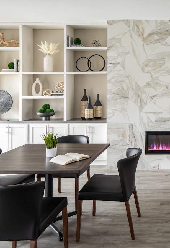 A modern dining room with a table set for four.