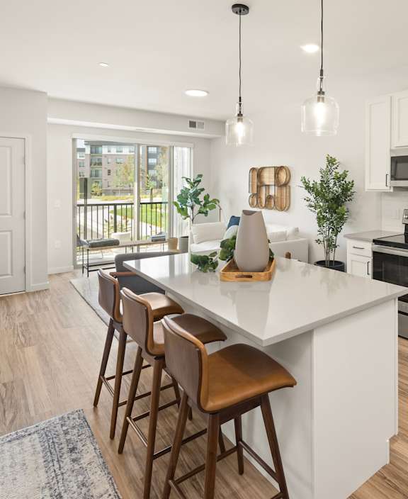 A modern kitchen with white cabinets and a central island.