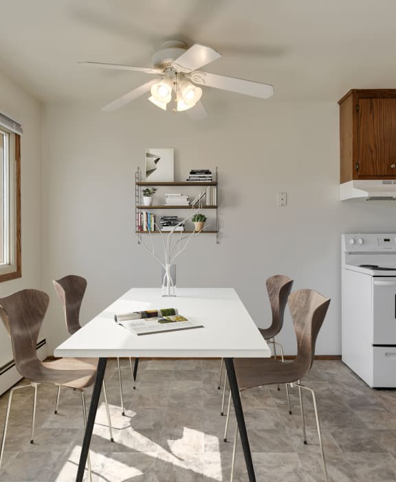 a kitchen with white appliances and a white dining table with four chairs at Hamline Terrace, Roseville, Minnesota