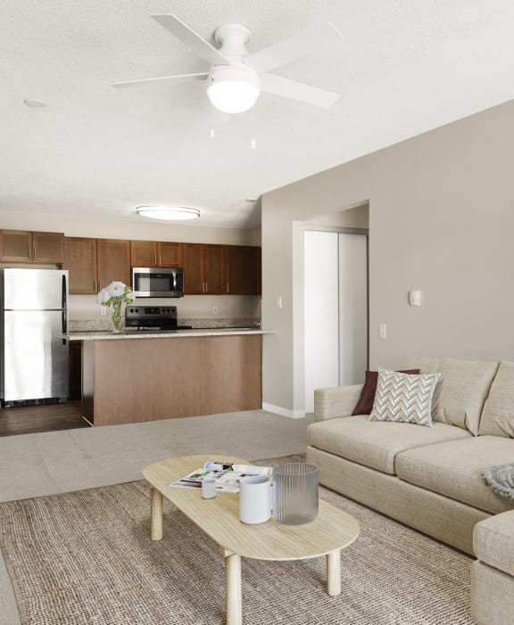 A living room with a couch, coffee table, and a ceiling fan. at Hidden Valley, Minnesota, 55378
