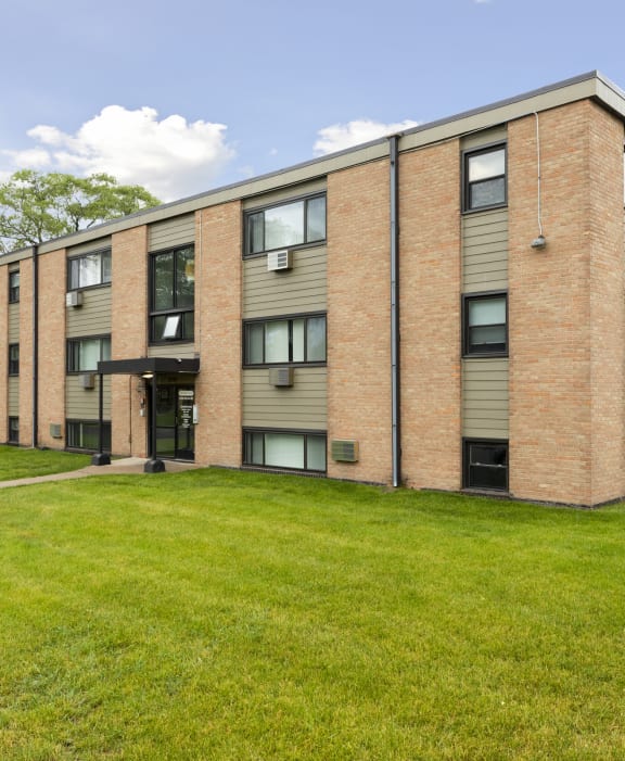 A large brick building with a green lawn in front. at Northeast Villas, Minnesota, 55421