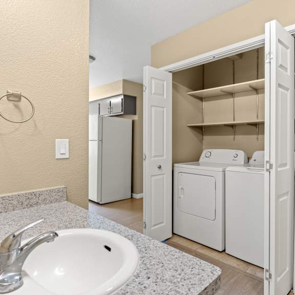 A white sink with a silver faucet in a bathroom. at Redwood Cove Apartments, California, 95928