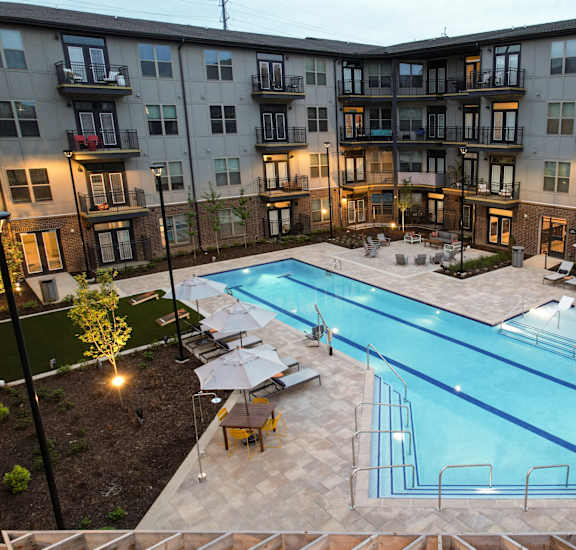 an aerial view of an apartment building with a swimming pool