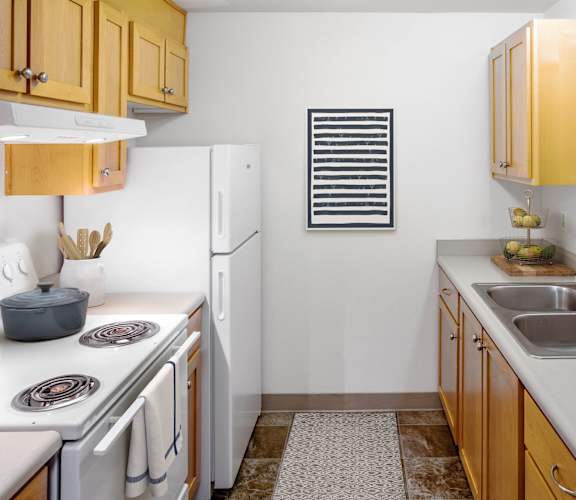 a kitchen with white appliances and wooden cabinets